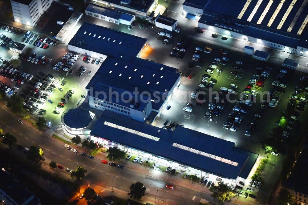 Aerial image at night Berlin - Night lighting car dealership building of Volkswagen Automobile Berlin GmbH on Goerzallee in the district Lichterfelde in Berlin, Germany