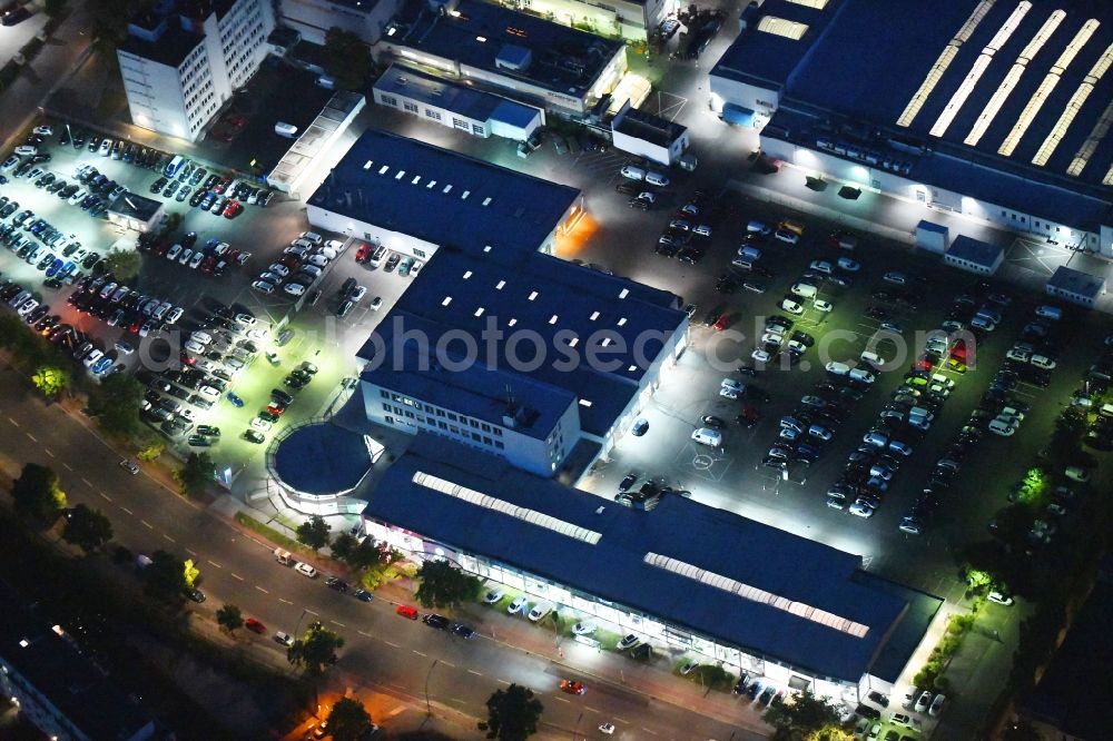 Berlin at night from above - Night lighting car dealership building of Volkswagen Automobile Berlin GmbH on Goerzallee in the district Lichterfelde in Berlin, Germany