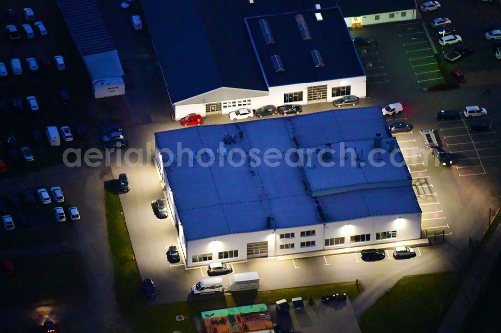 Bernau at night from the bird perspective: Night lighting car dealership building Zemke Autohaus Bernau in Bernau in the state Brandenburg, Germany