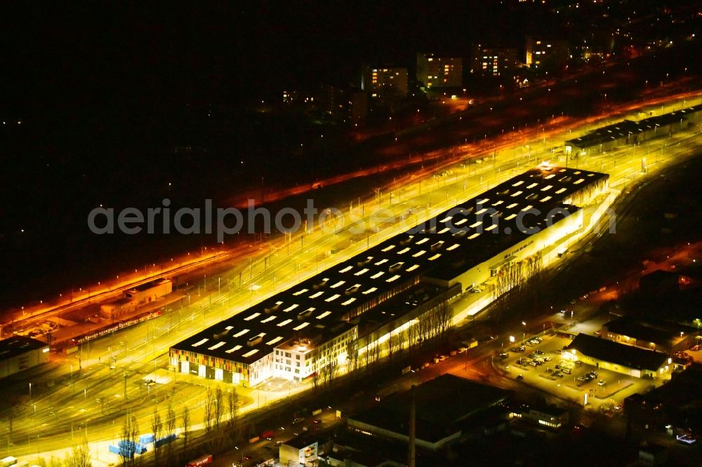 Aerial image at night Köln - Night lighting railway depot and repair shop for maintenance and repair of trains of passenger transport of the series ICE factory in the district Bilderstoeckchen in Cologne in the state North Rhine-Westphalia, Germany