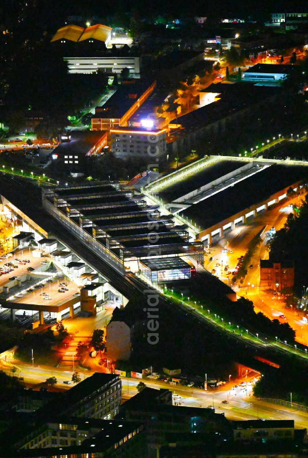 Berlin at night from above - Night lighting station building and track systems of the S-Bahn station Berlin Suedkreuz in the district Tempelhof-Schoeneberg in Berlin, Germany