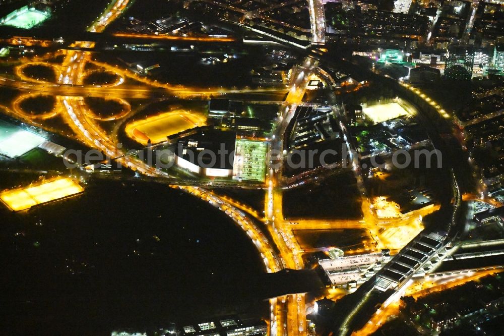 Aerial photograph at night Berlin - Night lighting Station building and track systems of the S-Bahn station Berlin Suedkreuz on motorway A100 in the district Tempelhof-Schoeneberg in Berlin, Germany