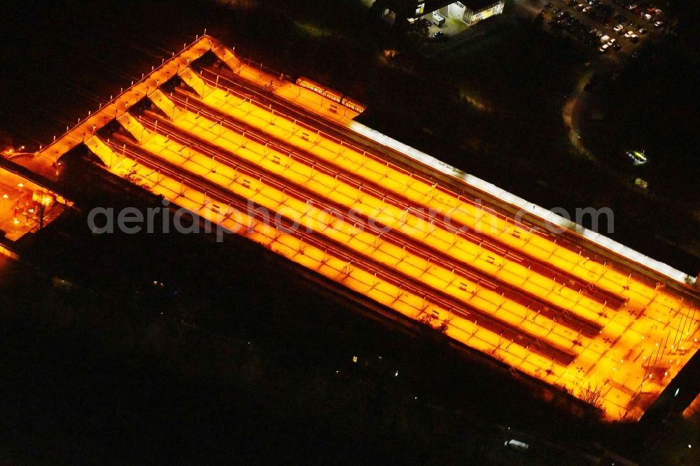 Berlin at night from the bird perspective: Night lighting Station building and track systems of the S-Bahn station on Flatowallee in the district Charlottenburg in Berlin, Germany