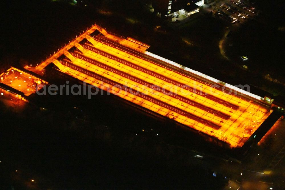 Aerial photograph at night Berlin - Night lighting Station building and track systems of the S-Bahn station on Flatowallee in the district Charlottenburg in Berlin, Germany