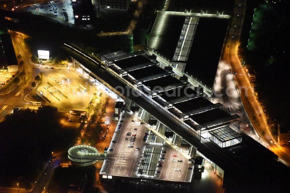 Berlin at night from the bird perspective: Night view station building and track systems of the S-Bahn station Suedkreuz in Berlin