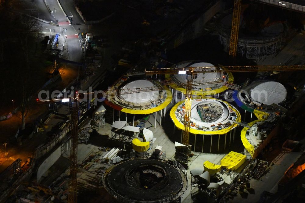 Aerial image at night Stuttgart - Night lighting building of the main station of the railway and construction site for the development project Stuttgart 21 in Stuttgart in the state of Baden-Wurttemberg