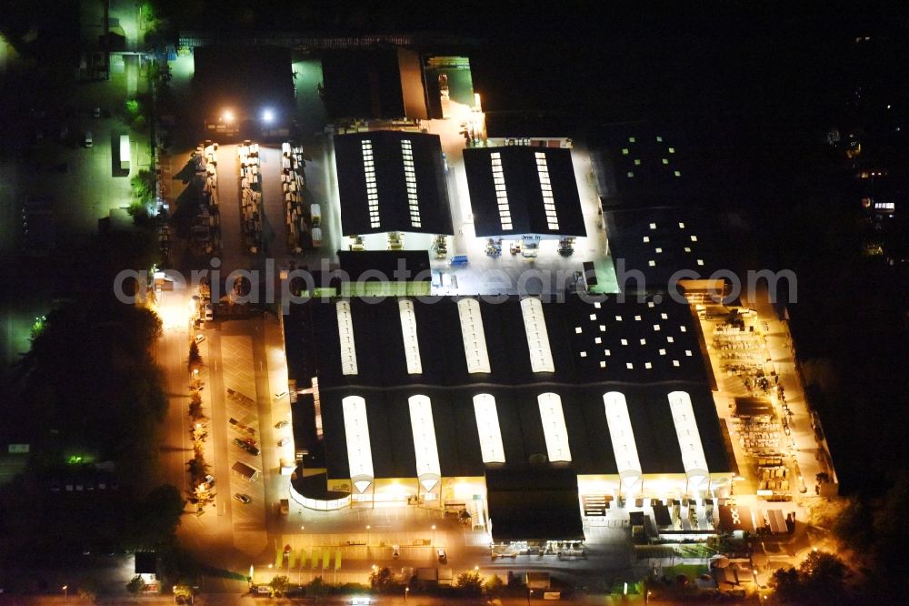 Aerial image at night Berlin - Night view wood Possling construction market Mahlsdorf on Landsberger Strasse in Berlin