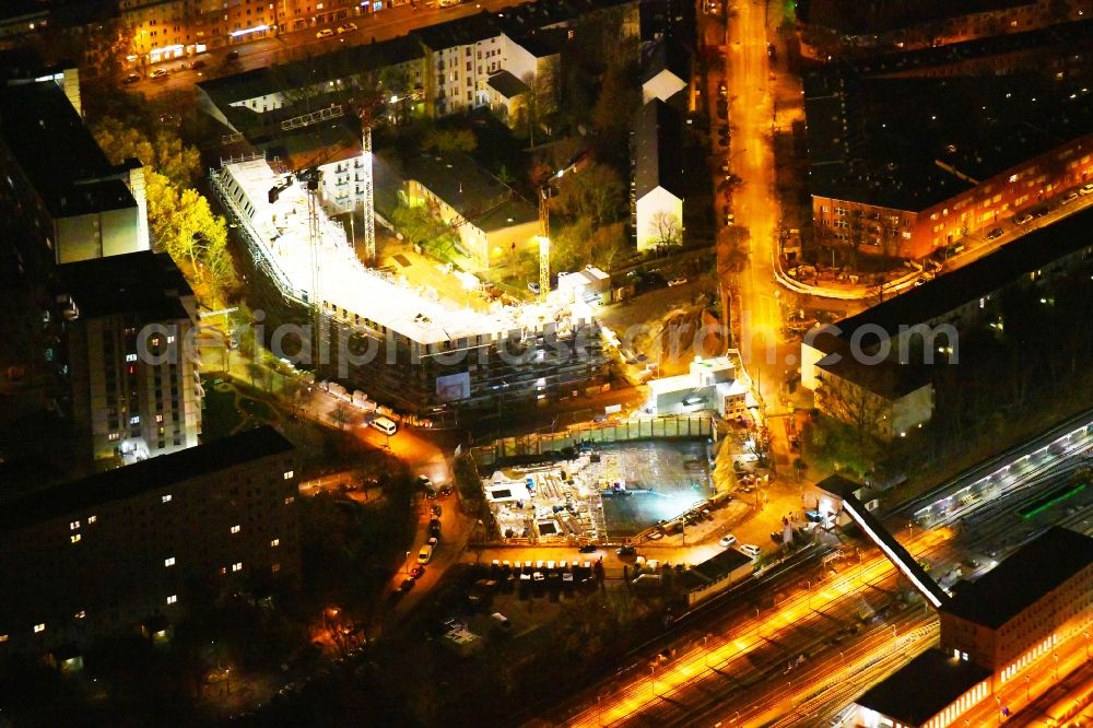 Aerial image at night Berlin - Night lighting Residential construction site with multi-family housing development- on the Rosenfelder Ring corner Skandinavische Strasse in the district Lichtenberg in Berlin, Germany