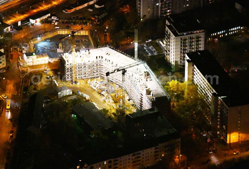 Aerial image at night Berlin - Night lighting Residential construction site with multi-family housing development- on the Rosenfelder Ring corner Skandinavische Strasse in the district Lichtenberg in Berlin, Germany