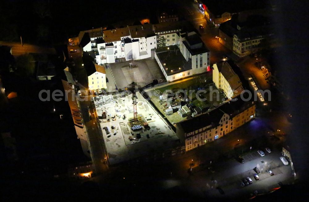 Arnstadt at night from above - Night lighting New construction of the building complex of the shopping center Arnstadt-Center between Karl-Marien-Strasse, Muhmengasse and Turnvater-Jahn-Strasse in Arnstadt in the state Thuringia, Germany