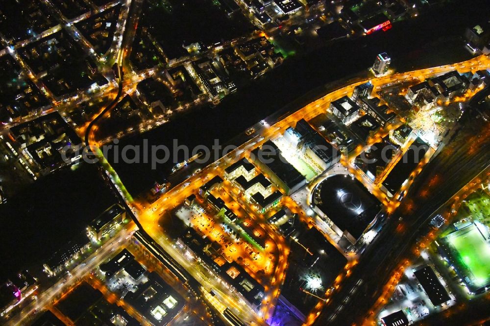 Aerial image at night Berlin - Night lighting Construction site for the new building eines Kino- Freizeit- and Hotelkomplexes on Anschutz- Areal along of Muehlenstrasse in the district Bezirk Friedrichshain-Kreuzberg in Berlin, Germany