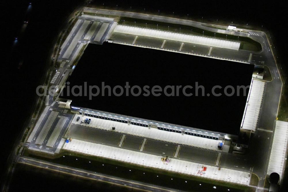 Kiekebusch at night from above - Night lighting construction site for the construction of a logistics center of the Achim Walder retailer Amazon in Kiekebusch in the state of Brandenburg, Germany