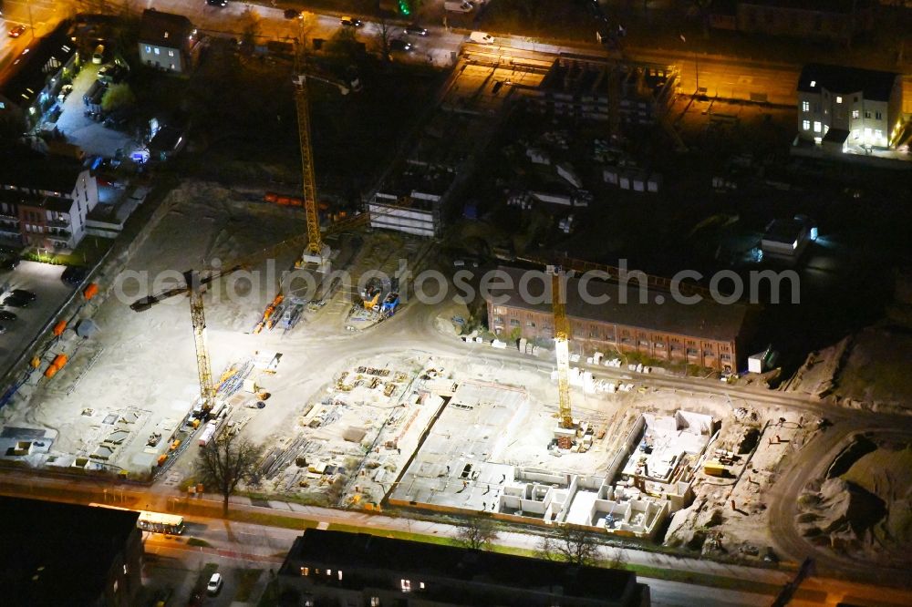 Berlin at night from above - Night lighting Construction site to build a new multi-family residential complex of Gut Alt-Biesdorf on Weissenhoeher Strasse in Berlin, Germany