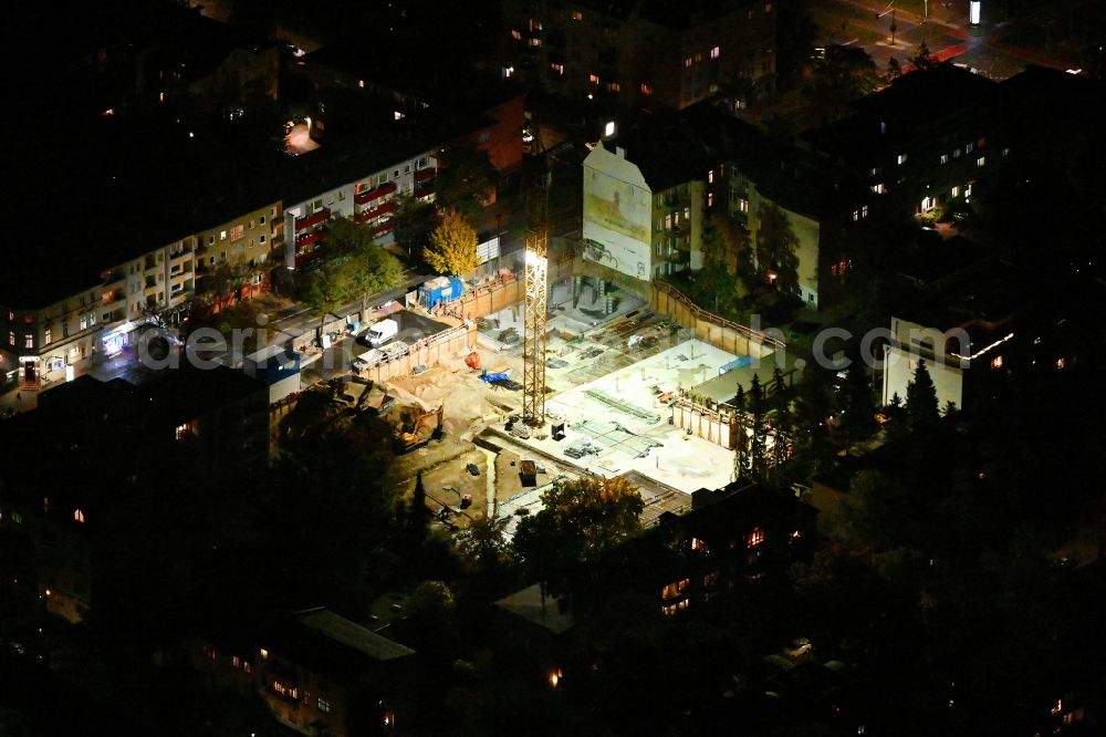 Aerial photograph at night Berlin - Night lighting construction site for the new construction of a multi-family residential building as a townhouse Karllotta on street Albrechtstrasse in the district Steglitz in Berlin, Germany