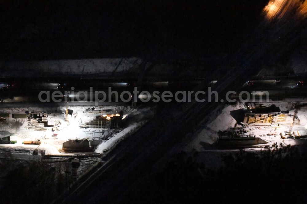 Aerial image at night Michendorf - Night lighting Construction for the renovation of the railway bridge building to route the train tracks crossing course of motorway BAB A10 in Michendorf in the state Brandenburg