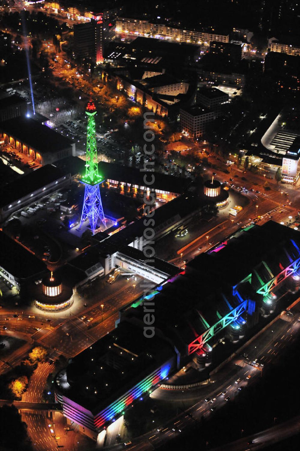 Berlin at night from the bird perspective: Nachtaufnahme: Sicht auf das beleuchtete Messegelände mit dem ICC Konfesscenter am Funkturm anlässlich des Festival Of Lights 2010 in Berlin. Nightshot: View to the illuminated exhibition ground with the Radio Tower Berlin in celebration of the Festival Of Lights 2010.