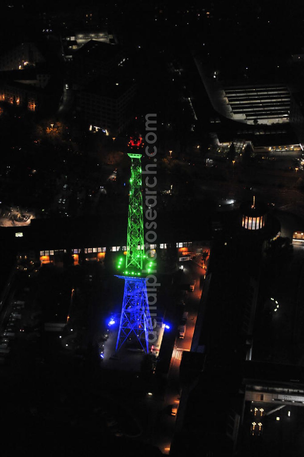 Berlin at night from above - Nachtaufnahme: Sicht auf das beleuchtete Messegelände mit dem Funkturm anlässlich des Festival Of Lights 2010 in Berlin. Nightshot: View to the illuminated exhibition ground with the Radio Tower Berlin in celebration of the Festival Of Lights 2010.