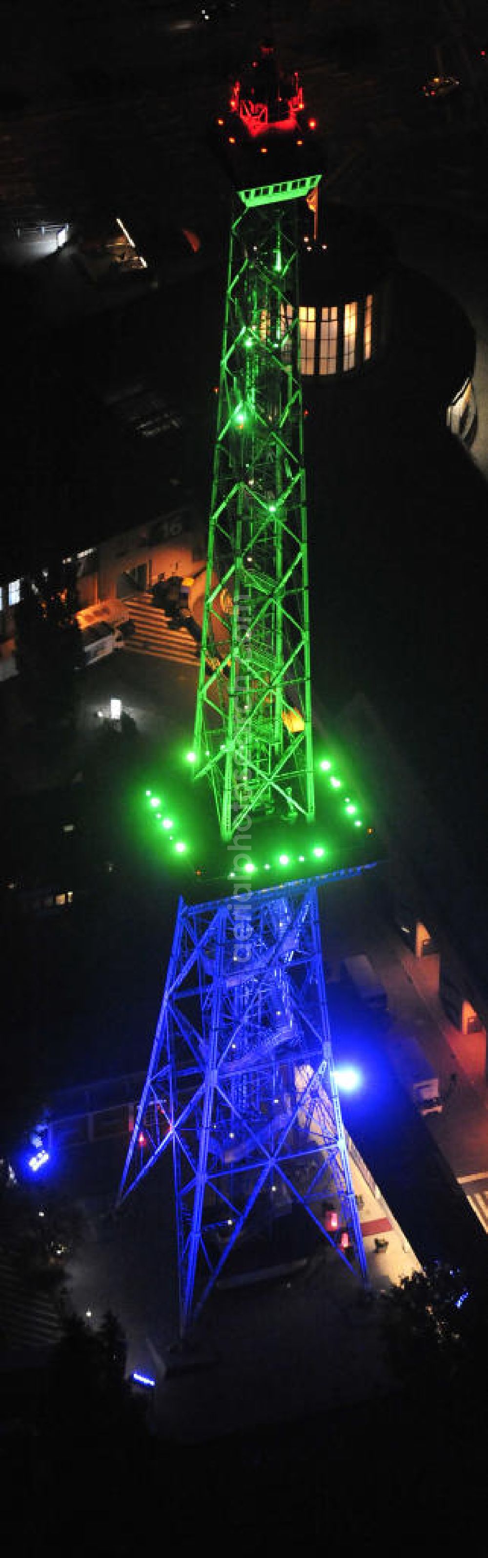 Berlin at night from the bird perspective: Nachtaufnahme: Sicht auf das beleuchtete Messegelände mit dem Funkturm anlässlich des Festival Of Lights 2010 in Berlin. Nightshot: View to the illuminated exhibition ground with the Radio Tower Berlin in celebration of the Festival Of Lights 2010.