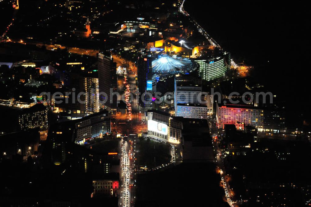 Aerial photograph at night Berlin - Nachtluftbild vom nächtlichen Berlin anläßlich des Festival of Lights in der Berliner Innenstadt. Hunderttausende Besucher strömten am letzten Wochenende des Festivals zu den illuminierten Gebäuden und angestrahlten Bereichen der Innenstadt. Blick auf den Leipziger Platz und die Potsdamer Straße über das Gebiet Potsdamer Platz den Berliner Stadtteilen Mitte und Tiergarten. Im Vordergrund ist der Deutsche-Bahn-Tower und der Kollhoff-Tower, im Hintergrund das Sony-Center und die Berliner Philharmonie. Night shot of Berlin's illuminated inner-city; here the square Leipziger Platz with view to the street Potsdamer Strasse in the area Potsdamer Platz. In the foreground the Deutsche-Bahn-Tower and the Kollhoff-Tower, behind it the Sony-Center and the Philharmonie.