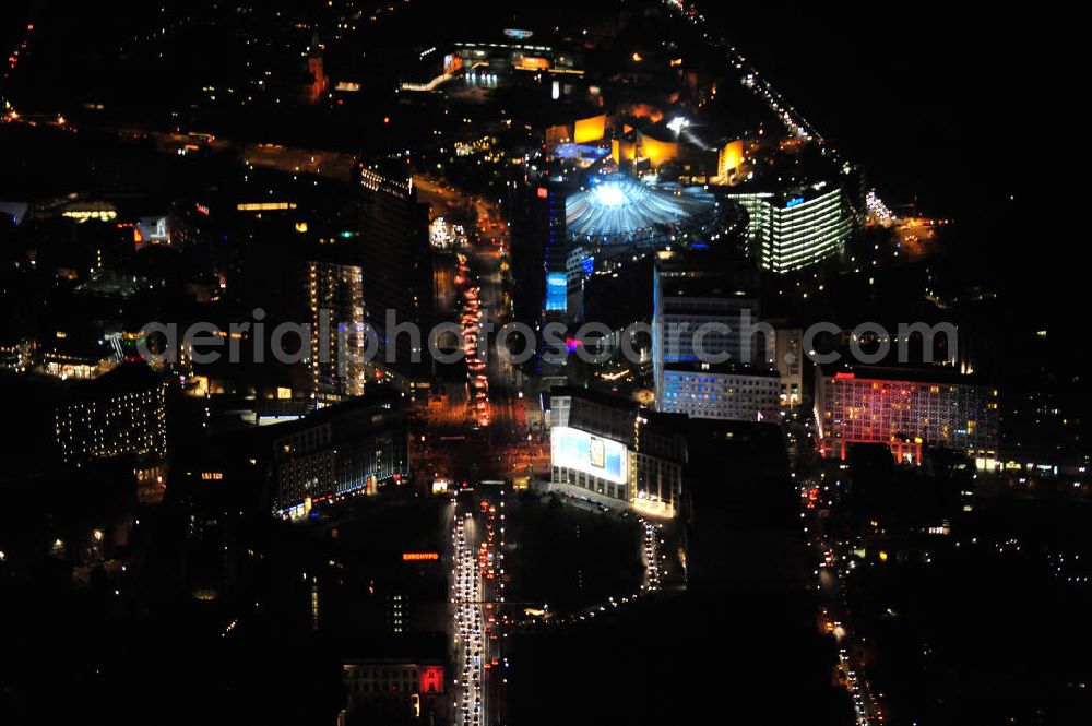 Aerial image at night Berlin - Nachtluftbild vom nächtlichen Berlin anläßlich des Festival of Lights in der Berliner Innenstadt. Hunderttausende Besucher strömten am letzten Wochenende des Festivals zu den illuminierten Gebäuden und angestrahlten Bereichen der Innenstadt. Blick auf den Leipziger Platz und die Potsdamer Straße über das Gebiet Potsdamer Platz den Berliner Stadtteilen Mitte und Tiergarten. Im Vordergrund ist der Deutsche-Bahn-Tower und der Kollhoff-Tower, im Hintergrund das Sony-Center und die Berliner Philharmonie. Night shot of Berlin's illuminated inner-city; here the square Leipziger Platz with view to the street Potsdamer Strasse in the area Potsdamer Platz. In the foreground the Deutsche-Bahn-Tower and the Kollhoff-Tower, behind it the Sony-Center and the Philharmonie.