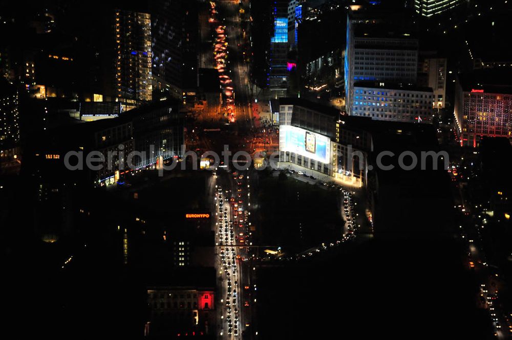 Berlin at night from above - Nachtluftbild vom nächtlichen Berlin anläßlich des Festival of Lights in der Berliner Innenstadt. Hunderttausende Besucher strömten am letzten Wochenende des Festivals zu den illuminierten Gebäuden und angestrahlten Bereichen der Innenstadt. Blick auf den Leipziger Platz und die Potsdamer Straße über das Gebiet Potsdamer Platz den Berliner Stadtteilen Mitte und Tiergarten. Im Vordergrund ist der Deutsche-Bahn-Tower und der Kollhoff-Tower, im Hintergrund das Sony-Center und die Berliner Philharmonie. Night shot of Berlin's illuminated inner-city; here the square Leipziger Platz with view to the street Potsdamer Strasse in the area Potsdamer Platz. In the foreground the Deutsche-Bahn-Tower and the Kollhoff-Tower, behind it the Sony-Center and the Philharmonie.