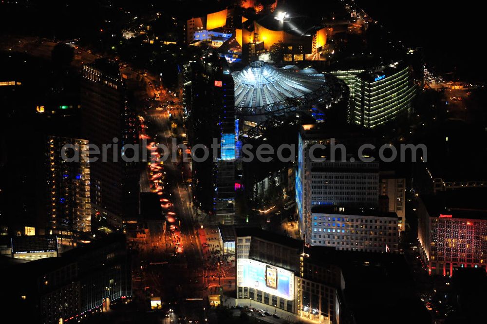 Aerial photograph at night Berlin - Nachtluftbild vom nächtlichen Berlin anläßlich des Festival of Lights in der Berliner Innenstadt. Hunderttausende Besucher strömten am letzten Wochenende des Festivals zu den illuminierten Gebäuden und angestrahlten Bereichen der Innenstadt. Blick auf den Leipziger Platz und die Potsdamer Straße über das Gebiet Potsdamer Platz den Berliner Stadtteilen Mitte und Tiergarten. Im Vordergrund ist der Deutsche-Bahn-Tower und der Kollhoff-Tower, im Hintergrund das Sony-Center und die Berliner Philharmonie. Night shot of Berlin's illuminated inner-city; here the square Leipziger Platz with view to the street Potsdamer Strasse in the area Potsdamer Platz. In the foreground the Deutsche-Bahn-Tower and the Kollhoff-Tower, behind it the Sony-Center and the Philharmonie.