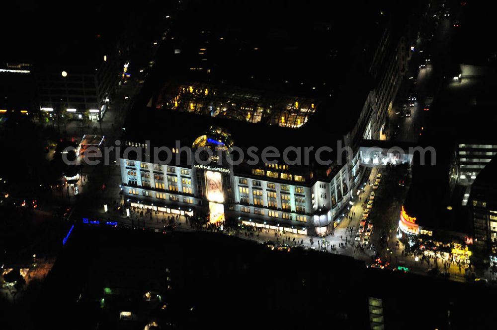 Berlin at night from the bird perspective: Nachtluftbild: Blick auf das KaDeWe , das Kaufhaus des Westens am Wittenbergplatz in Berlin - Schöneberg. Das KaDeWe ist ein deutsches Luxuswarenhaus, das von Adolf Jandorf gegründet und am 27. März 1907 eröffnet wurde. Es ist heute mit 60.000 m² Verkaufsfläche das zweitgrößte Warenhaus Kontinentaleuropas. Es befindet sich in der Tauentzienstraße in Berlin-Schöneberg am Wittenbergplatz und ist das bekannteste Warenhaus Deutschlands. Das KaDeWe gehört der Nicolas Berggruen Holdings GmbH. Night shot: view on the KaDeWe, the Department Store of the West at Wittenbergplatz in Berlin's district Schoeneberg. It is a german luxury department store founded by Adolf Jandorf, opened march 27th, 1907. Today it's europe's second largest department store with a selling space of 60.000 m², located in the street Tauentzienstrasse near the square Wittenbergplatz. It's Germany's the best known department store. The KaDeWe is belonging to Nicolas Berggruen Holdings GmbH.