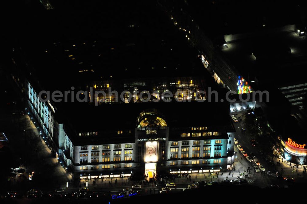 Aerial image at night Berlin - Nachtluftbild: Blick auf das KaDeWe , das Kaufhaus des Westens am Wittenbergplatz in Berlin - Schöneberg. Das KaDeWe ist ein deutsches Luxuswarenhaus, das von Adolf Jandorf gegründet und am 27. März 1907 eröffnet wurde. Es ist heute mit 60.000 m² Verkaufsfläche das zweitgrößte Warenhaus Kontinentaleuropas. Es befindet sich in der Tauentzienstraße in Berlin-Schöneberg am Wittenbergplatz und ist das bekannteste Warenhaus Deutschlands. Das KaDeWe gehört der Nicolas Berggruen Holdings GmbH. Night shot: view on the KaDeWe, the Department Store of the West at Wittenbergplatz in Berlin's district Schoeneberg. It is a german luxury department store founded by Adolf Jandorf, opened march 27th, 1907. Today it's europe's second largest department store with a selling space of 60.000 m², located in the street Tauentzienstrasse near the square Wittenbergplatz. It's Germany's the best known department store. The KaDeWe is belonging to Nicolas Berggruen Holdings GmbH.