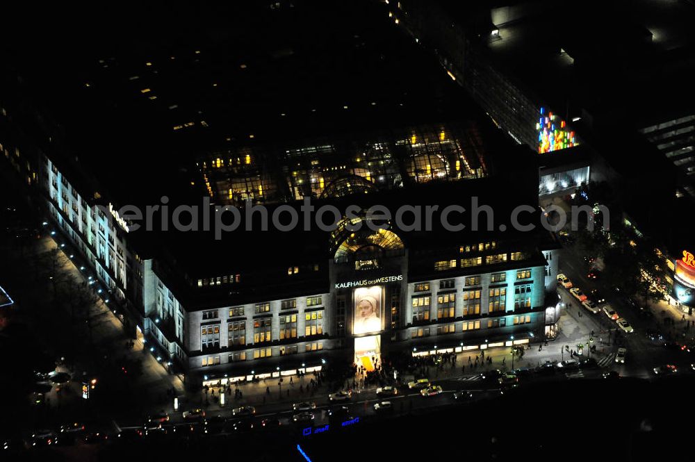 Berlin at night from the bird perspective: Nachtluftbild: Blick auf das KaDeWe , das Kaufhaus des Westens am Wittenbergplatz in Berlin - Schöneberg. Das KaDeWe ist ein deutsches Luxuswarenhaus, das von Adolf Jandorf gegründet und am 27. März 1907 eröffnet wurde. Es ist heute mit 60.000 m² Verkaufsfläche das zweitgrößte Warenhaus Kontinentaleuropas. Es befindet sich in der Tauentzienstraße in Berlin-Schöneberg am Wittenbergplatz und ist das bekannteste Warenhaus Deutschlands. Das KaDeWe gehört der Nicolas Berggruen Holdings GmbH. Night shot: view on the KaDeWe, the Department Store of the West at Wittenbergplatz in Berlin's district Schoeneberg. It is a german luxury department store founded by Adolf Jandorf, opened march 27th, 1907. Today it's europe's second largest department store with a selling space of 60.000 m², located in the street Tauentzienstrasse near the square Wittenbergplatz. It's Germany's the best known department store. The KaDeWe is belonging to Nicolas Berggruen Holdings GmbH.