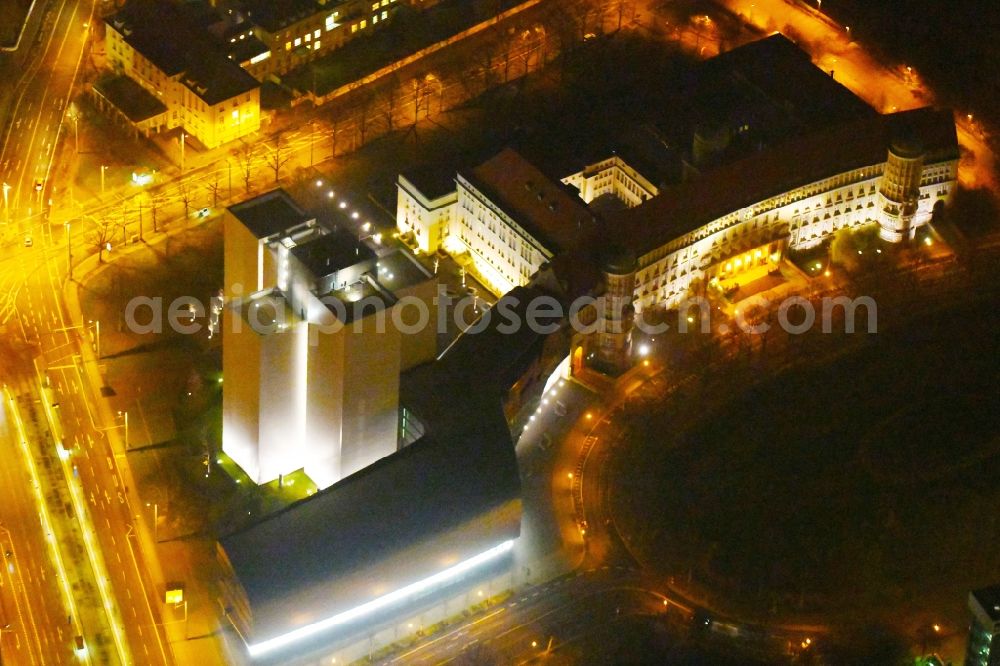 Aerial image at night Leipzig - Night lighting Library Building of Deutsche Nationalbibliothek Deutsches Buch- and Schriftmuseum Deutsche Nationalbibliothek on ensemble Deutscher Platz in the district Zentrum-Suedost in Leipzig in the state Saxony