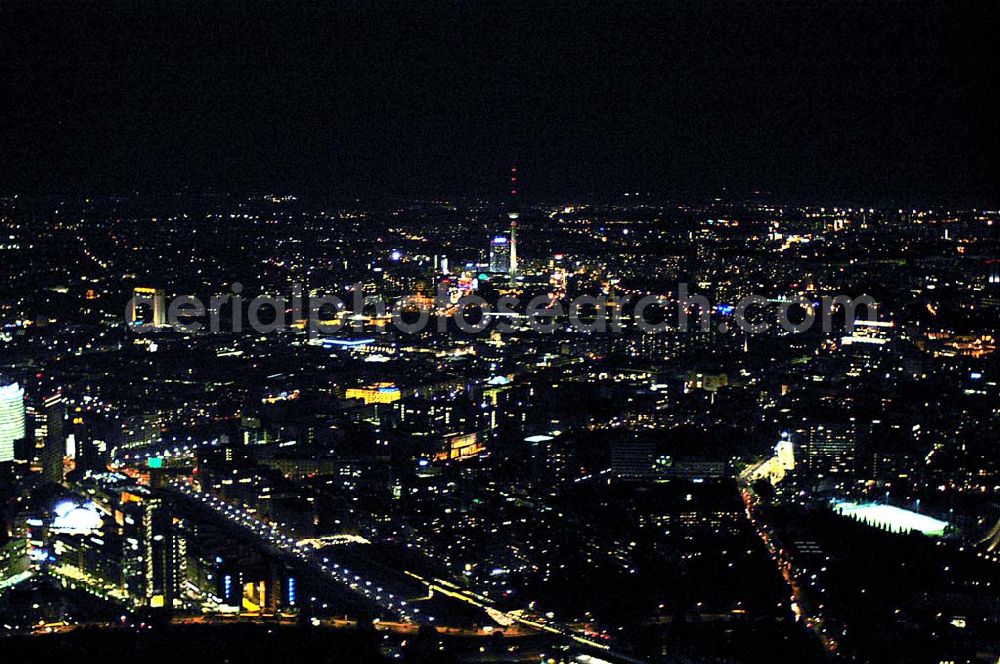 Aerial image at night Berlin - Blick auf den Potsdamer Platz, Anhalter Bahnhof mit dem Tempodrom und dem Stadtzentrum mit Fernsehturm im Hintergrund bei Nacht.