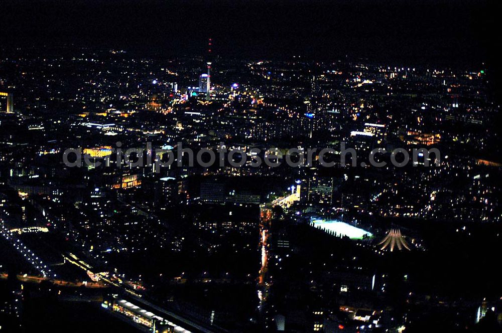 Berlin at night from above - Blick auf den Potsdamer Platz, Anhalter Bahnhof mit dem Tempodrom und dem Stadtzentrum mit Fernsehturm im Hintergrund bei Nacht.