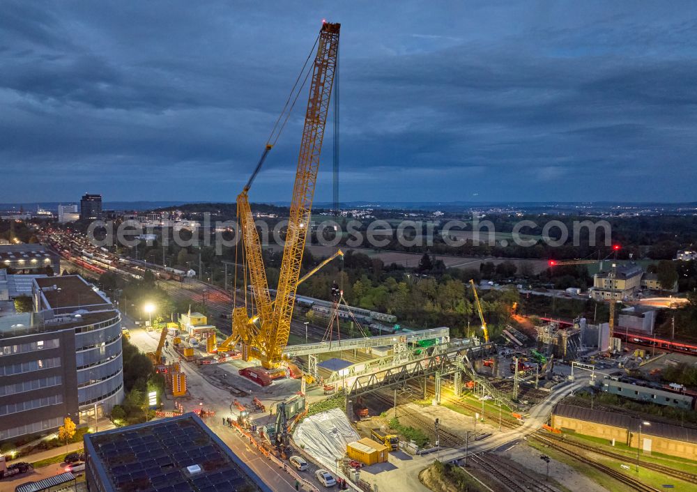 Kornwestheim at night from above - Night lights and lighting demolition work on the bridge structure with heavy-duty crane at the marshalling yard in Kornwestheim in the state of Baden-Wuerttemberg, Germany