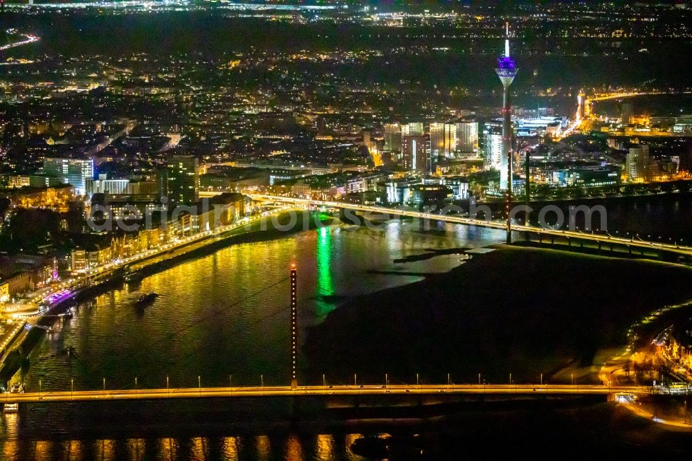 Düsseldorf at night from above - Night lighting bridge construction Oberkasseler Bruecke overlooking the inner city, the Rheinturm and the Rheinkniebruecke in Duesseldorf in the state North Rhine-Westphalia, Germany