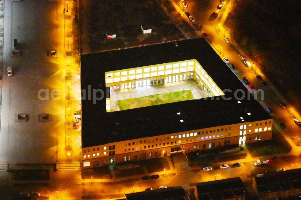 Aerial photograph at night Berlin - Night lighting Office building - Ensemble on Elsterwerdaer Platz in the district Biesdorf in Berlin, Germany