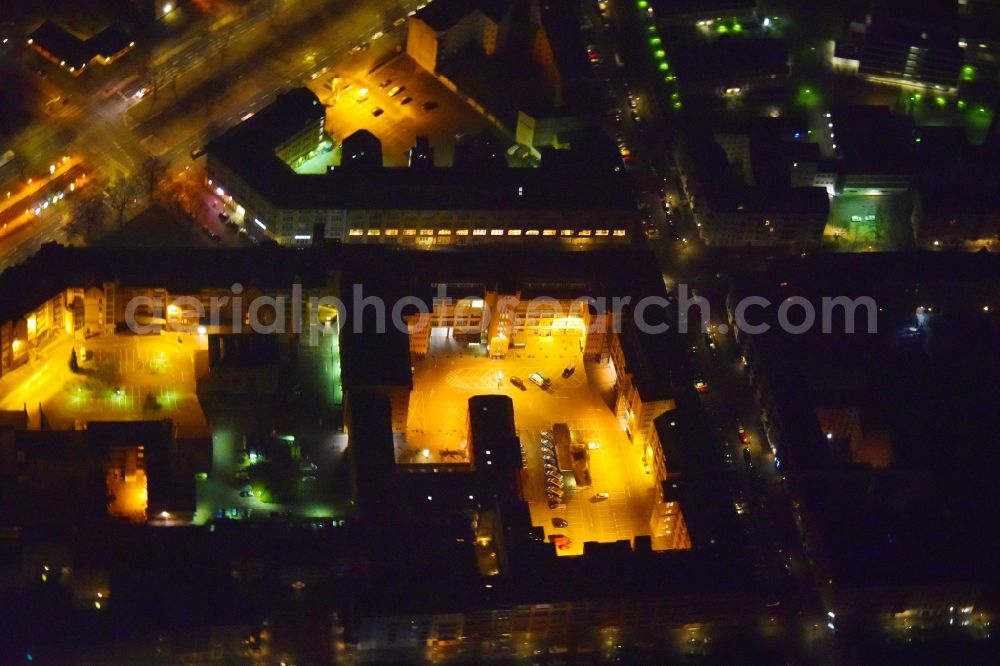 Aerial photograph at night Berlin - Night lighting Office building - Ensemble on Seestrasse - Liebenwalder Strasse - Groninger Strasse in the district Moabit in Berlin, Germany