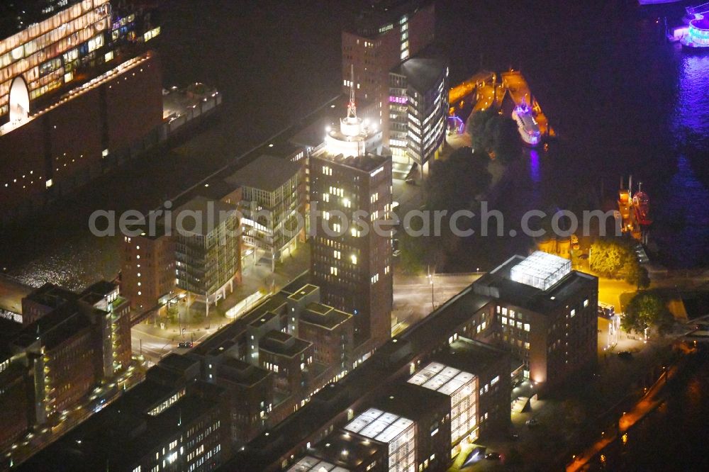 Aerial image at night Hamburg - Night lighting Office building - Ensemble Columbus Haus - Hanseatic Trade Center Tower Am Sandtorkai in Hamburg, Germany