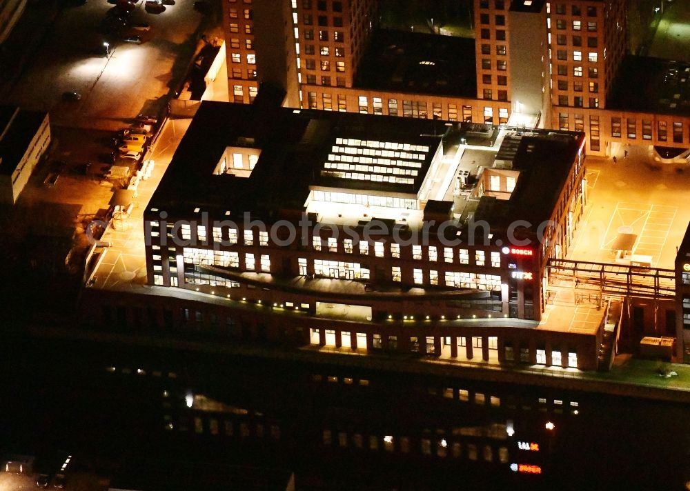 Berlin at night from the bird perspective: Night lighting office building - Ensemble on Ullsteinstrasse in the district Tempelhof in Berlin, Germany