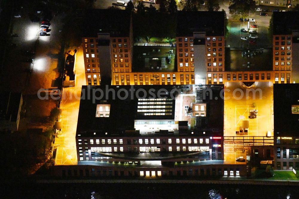 Aerial photograph at night Berlin - Night lighting office building - Ensemble on Ullsteinstrasse in the district Tempelhof in Berlin, Germany