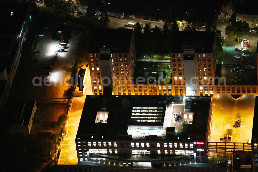 Aerial image at night Berlin - Night lighting office building - Ensemble on Ullsteinstrasse in the district Tempelhof in Berlin, Germany