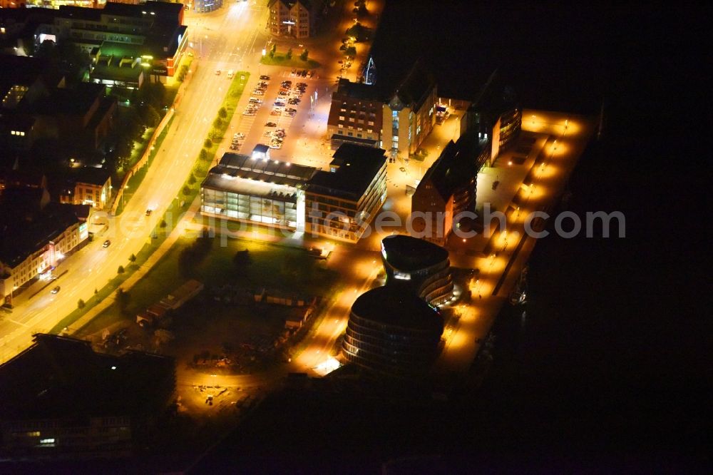 Aerial photograph at night Rostock - Night lighting Office building AIDA Cruises - German Branch of Costa Crociere S.p.A. in Rostock in the state Mecklenburg - Western Pomerania, Germany