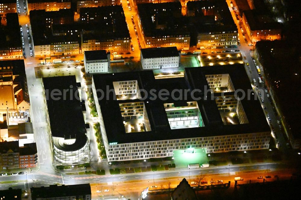 Nürnberg at night from the bird perspective: Night lighting office building of the administration and commercial building DATEV IT-Campus between Feuerleinstrasse, Adam-Klein-Strasse and Dr. Heimt-Sebiger-Strasse in the district Baerenschanze in Nuremberg in the state Bavaria, Germany