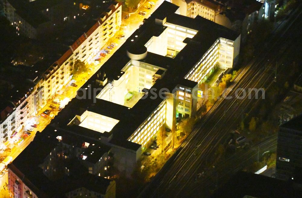 Aerial photograph at night Berlin - Night lighting Office building along the Neue Bahnhofstrasse in the district Friedrichshain in Berlin, Germany