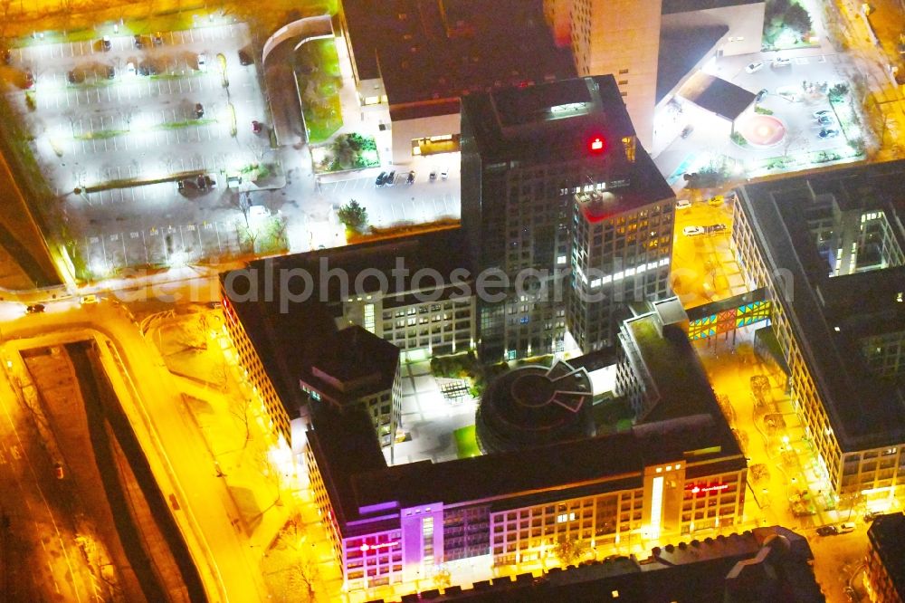 Leipzig at night from above - Night lighting Office and bank building complex in Loehrs Carre in Leipzig in the state of Saxony. Sachsen LB and Sparkasse Leipzig have their headquarters in the highrise