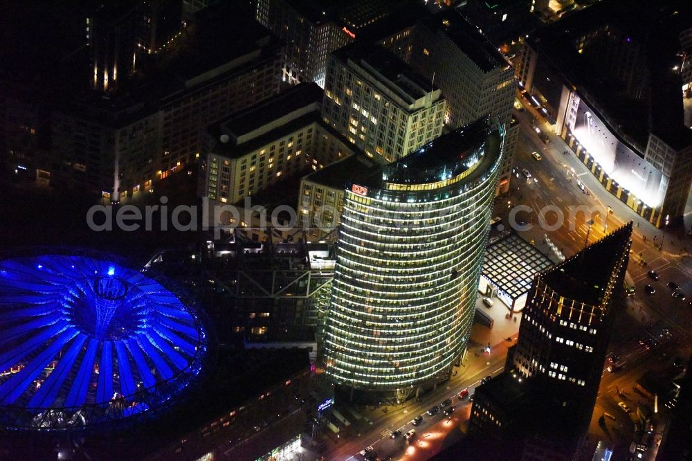 Aerial photograph at night Berlin - Night view office tower Bahn Tower at Sony Center on Potsdamer Platz in the Tiergarten part of Berlin in Germany