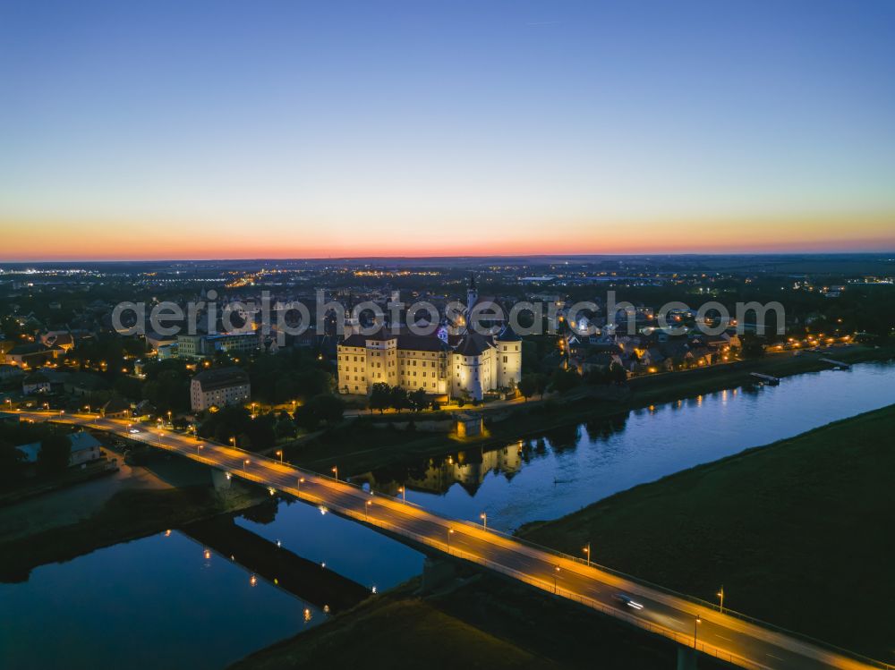 Torgau at night from above - Night lighting castle of the fortress Schloss und Schlosskirche Hartenfels in Torgau in the state Saxony