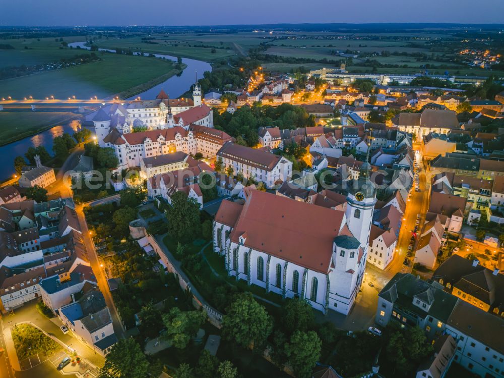 Torgau at night from above - Night lighting castle of the fortress Schloss und Schlosskirche Hartenfels in Torgau in the state Saxony