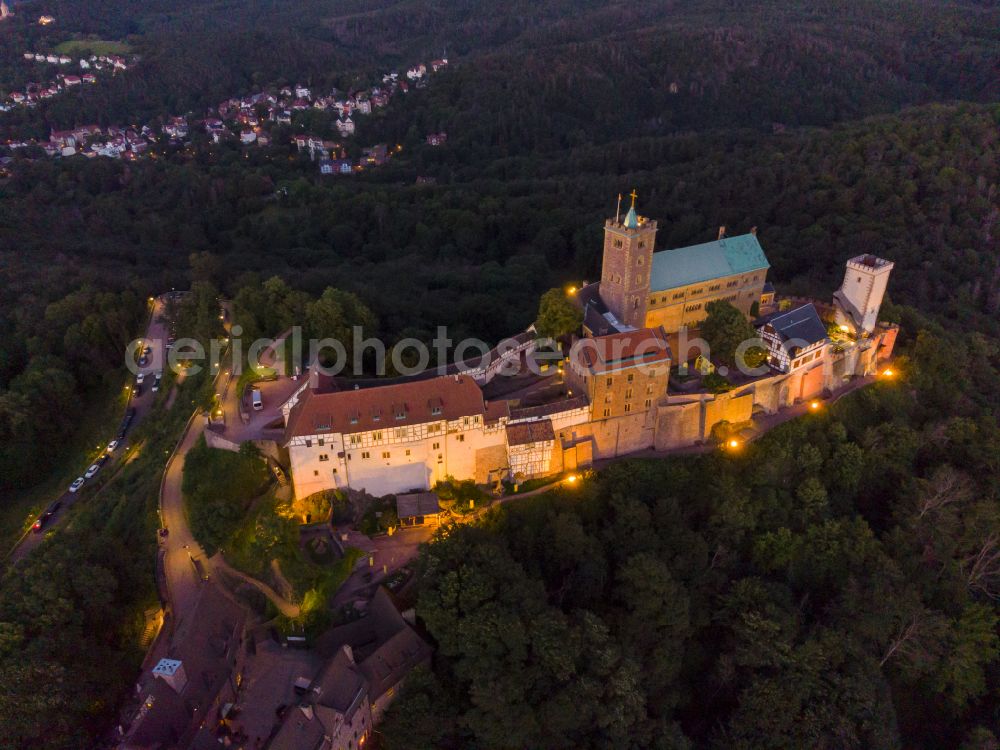 Eisenach at night from the bird perspective: Night lights and lighting at the Wartburg Fortress in Eisenach in the state of Thuringia, Germany