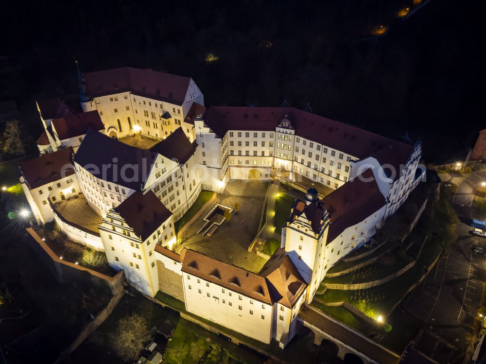 Aerial photograph at night Colditz - Night lighting walls of the castle complex on the plateau and castle on street Schlossgasse in Colditz in the state Saxony, Germany