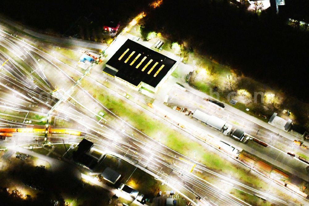 Aerial image at night Berlin - Night view company BVG underground service station at the Schlossweg in Berlin-Britz